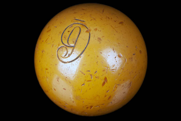 Yellow number 1 pool ball on green background. Horizontal composition with copy space.