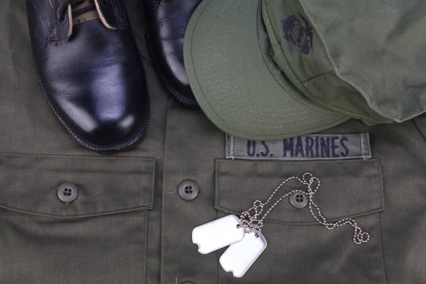 U.S. MARINES cap, dog tags and boots on olive green uniform