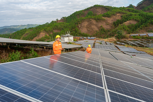 Two power engineers inspecting a solar power plant