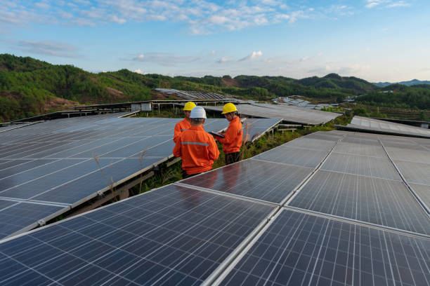 istock Solar panels on the top of the mountain, three workers are studying and discussing 1438931768