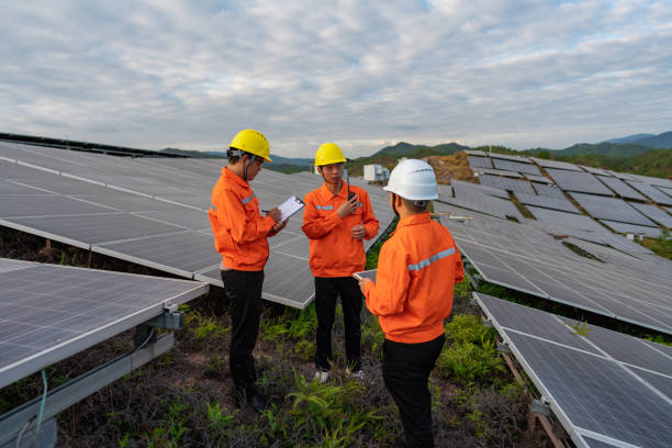 istock Solar panels on the top of the mountain, three workers are studying and discussing 1438931984