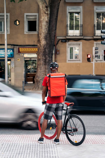 istock Delivery Man Riding Bike 1438932085