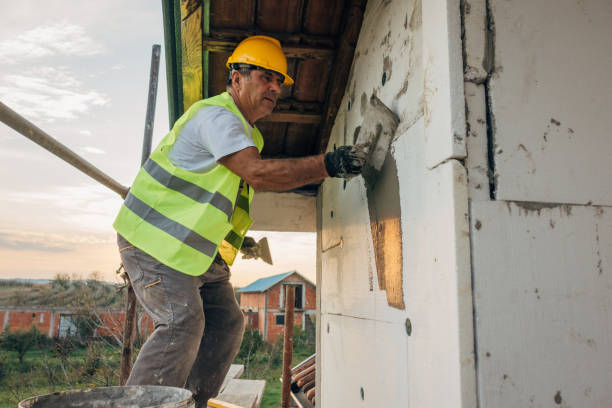 istock A construction worker builds the facade of a building 1438932341