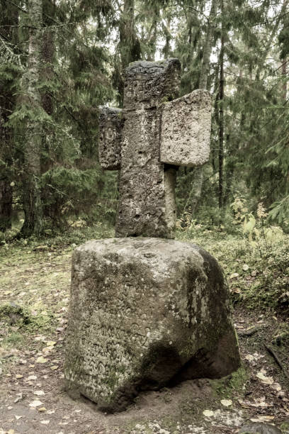 istock Worship stone cross near the forest road 1438935722