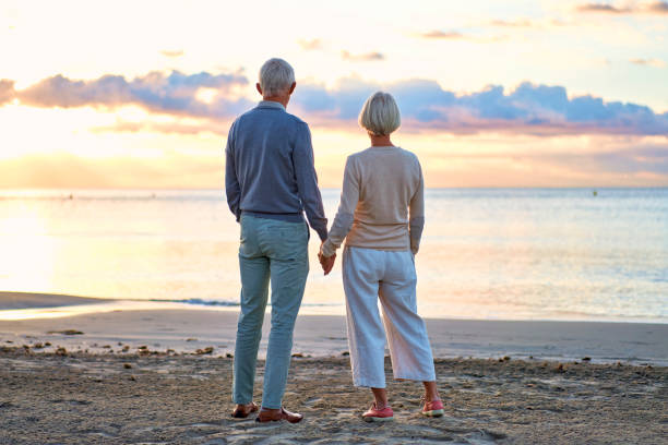 istock Senior couple on the beach 1438937636