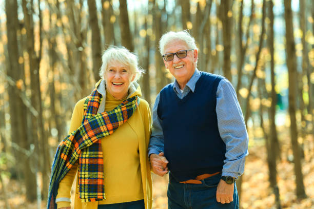 istock Beautiful Elderly couple embracing in autumn park 1438939970
