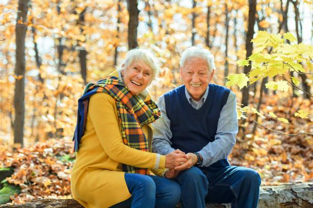 istock Beautiful Elderly couple embracing in autumn park 1438940007
