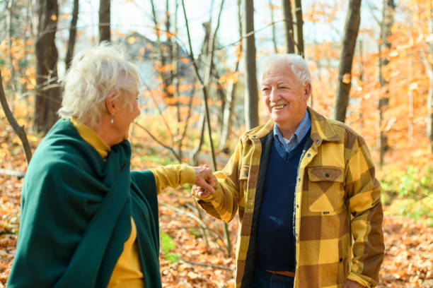 istock Beautiful Elderly couple embracing in autumn park 1438940034