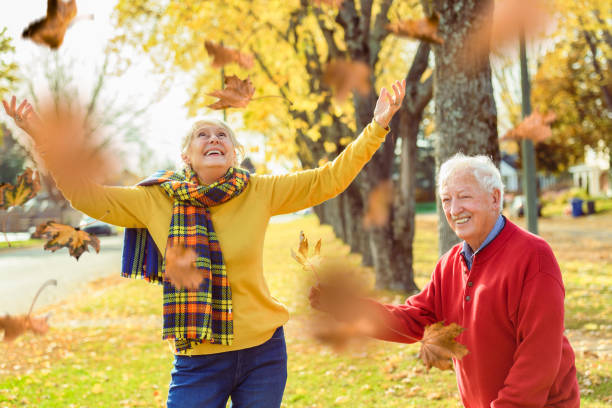 istock Beautiful Elderly couple embracing in autumn park 1438940140