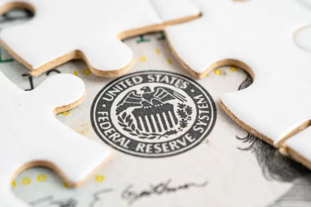 Photo of FED The Federal Reserve System with jigsaw puzzle paper, the central banking system of the United States of America.