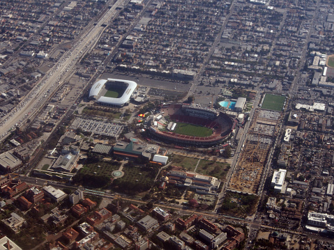 Los Angeles - October 26, 2018: Aerial of Los Angeles Memorial Coliseum, Banc of California Stadium, LA84 Foundation/John C. Argue Swim Stadium, California Science Center, and Natural History Museum of Los Angeles County. The stadium serves as the home to the University of Southern California (USC) Trojans football team of the Pac-12 Conference. It is also the temporary home of the Los Angeles Rams of the National Football League (NFL).