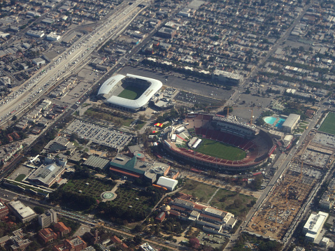 Los Angeles - October 26, 2018: Aerial of Los Angeles Memorial Coliseum, Banc of California Stadium, LA84 Foundation/John C. Argue Swim Stadium, California Science Center, and Natural History Museum of Los Angeles County. The stadium serves as the home to the University of Southern California (USC) Trojans football team of the Pac-12 Conference. It is also the temporary home of the Los Angeles Rams of the National Football League (NFL).