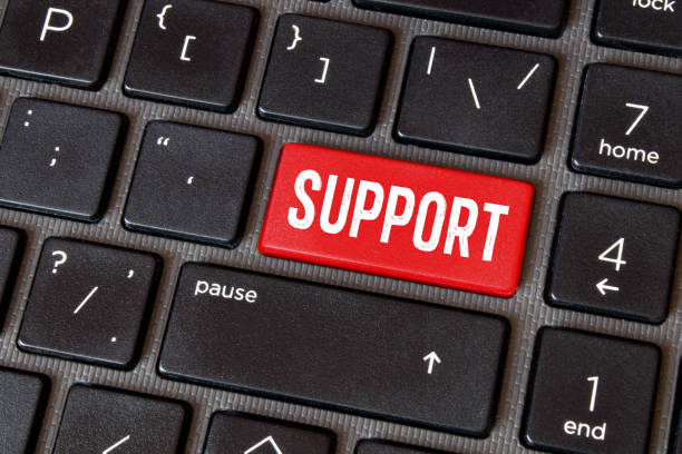 istock Close-up green button with the word support, on a black keyboard. Creative background, copy space. 1438942754