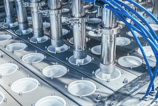 Indian employee working at a manufacturing factory assembling water pumps - production line concepts