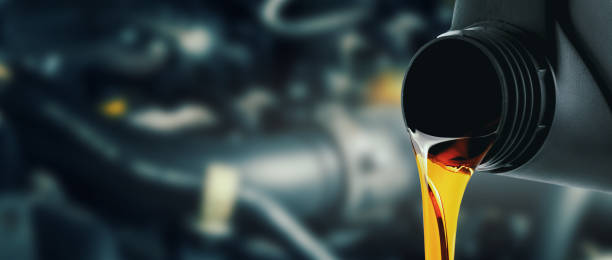istock change and pour new car engine oil into the motor. banner with copy space 1438944265