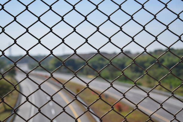 Chain link fence on the highway. as a roadside barrier