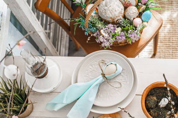 istock Table decoration for Easter celebration in kitchen.Tablescape for Easter holiday at home.Family religious traditional festive christianity,catholic meal food.Pop color eggs,cake,fun bunny,candy sweet 1438948756