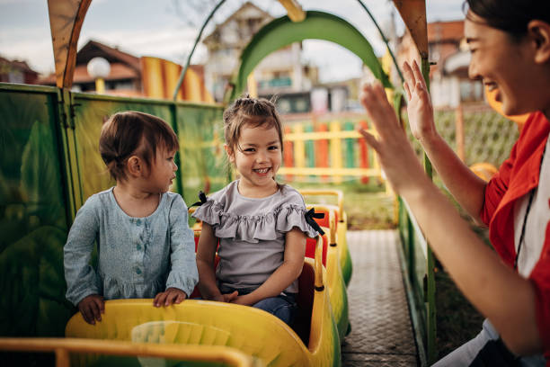 istock Mother with daughters is amusement park 1438949260