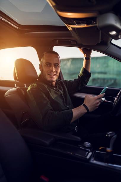 istock Young man sitting in the car with light falling into it 1438951776