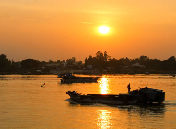 istock Silhouette sunset on Tien River, Dong Thap province 1438952010