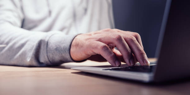 istock Closeup of male hand typing laptop computer keyboard 1438952224