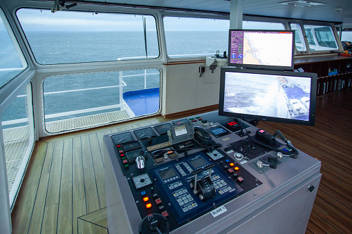 ijmuiden, Netherlands – September 01, 2017: The center console in the wheelhouse of a ferry. There are a lot of buttons and computer screens designed for steering the ship