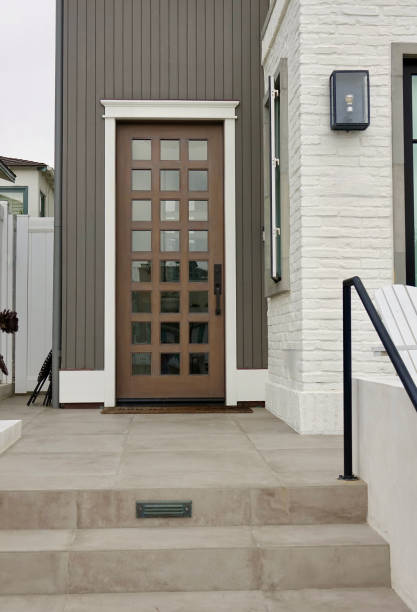 istock Modern home with tall front door with square windows 1438955388