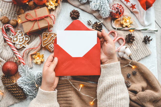 istock New Year's envelope with a letter in hands with a place for your text 1438956188