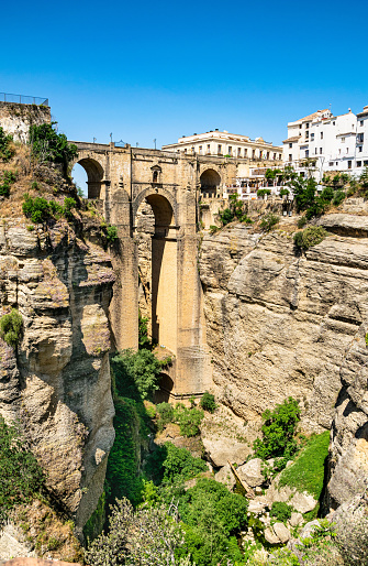 A portrait image of Puente Nuevo connecting the heart on the town of Ronda in southern Spain