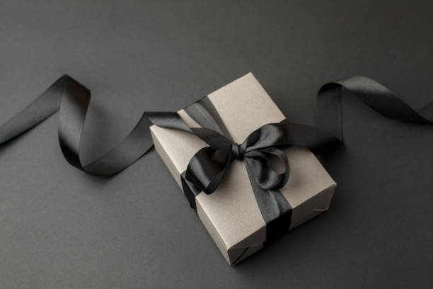 istock Craft gift box on a dark background, decorated with a textured bow, creating a romantic luxury atmosphere. For birthday, anniversary presents, gift post cards, banner, flyer, invitation, voucher 1438961849