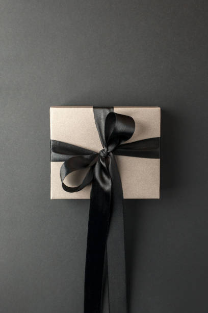 istock Craft gift box on a dark background, decorated with a textured bow, creating a romantic luxury atmosphere. For birthday, anniversary presents, gift post cards, banner, flyer, invitation, voucher 1438961889