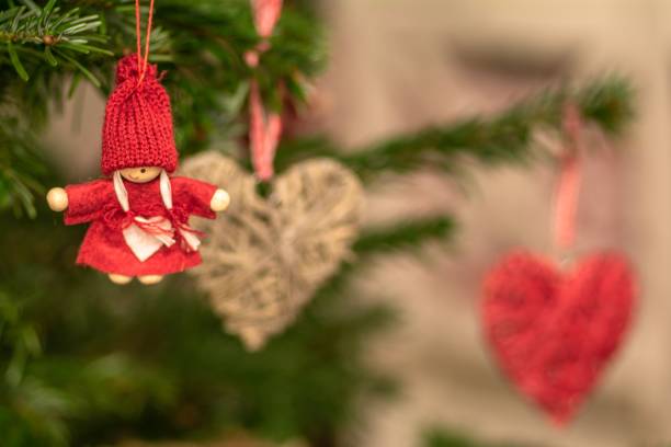 istock Closeup of christmas ornaments hanging on a tree 1438963539