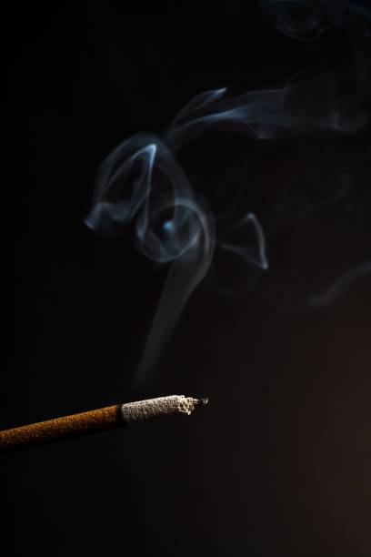 istock burning incense rising in smoke on a black background 1438964330