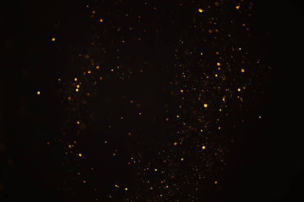 istock Glowing golden glitter bokeh festive lights abstract dark overlay 1438964346