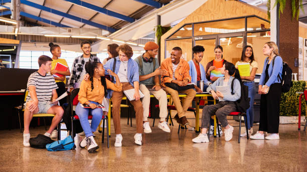 istock Diverse group of young college students hanging out at school 1438964920
