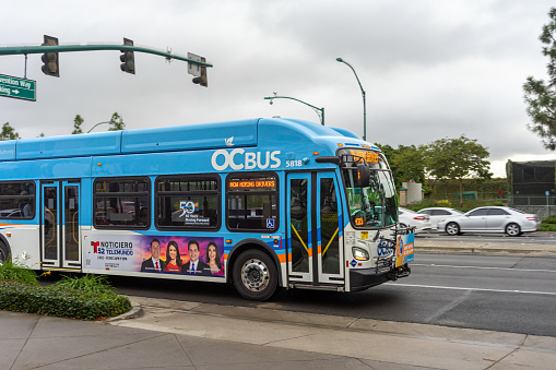 Anaheim, CA, USA – November 2, 2022: A Orange County Transit Authority (OCTA) bus travels on Harbor Blvd in Anaheim, California.