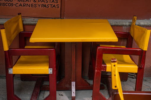 Close up of a Red and Yellow Table and Chair at a local Restaurant in Isla Mujeres