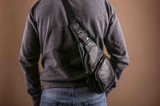 men leather sling bag is on person close up
