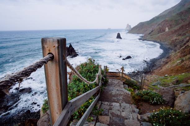 istock Descending rustic staircase leading to the a mountain shoreline 1438966892