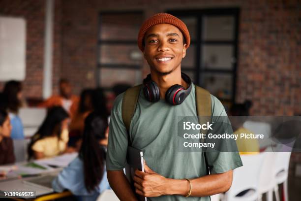 Smiling Young Male College Student Wearing Headphones Standing In A Classroom Stock Photo - Download Image Now