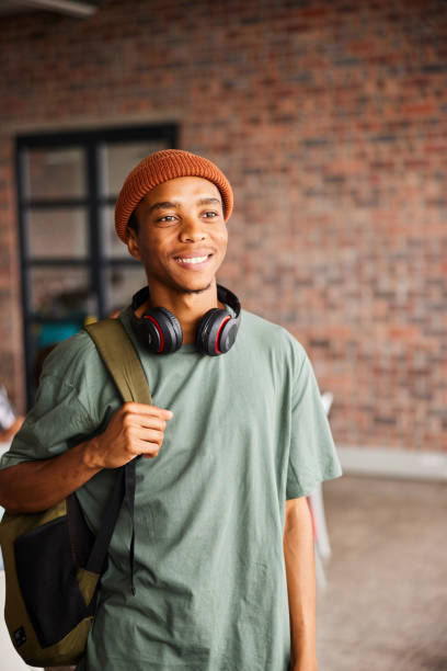 istock Smiling young male collage student standing in a class 1438972102