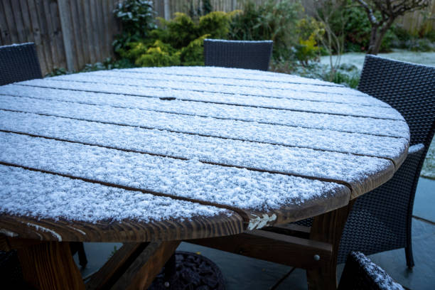 A light dusting of snow on a Garden table.