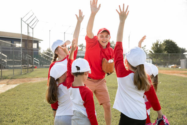 istock Team huddles with coach during little league baseball game 1438975832