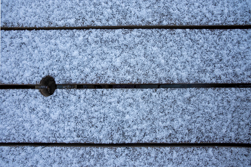 A light dusting of snow on a Garden table.