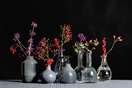 A collection of vases with a variety of berries. High quality photo