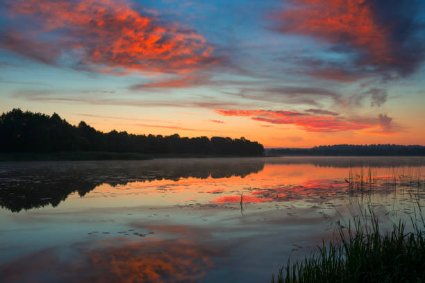 istock Pastoral landscape with dramatic sky on the lake in Belarus 1438979672