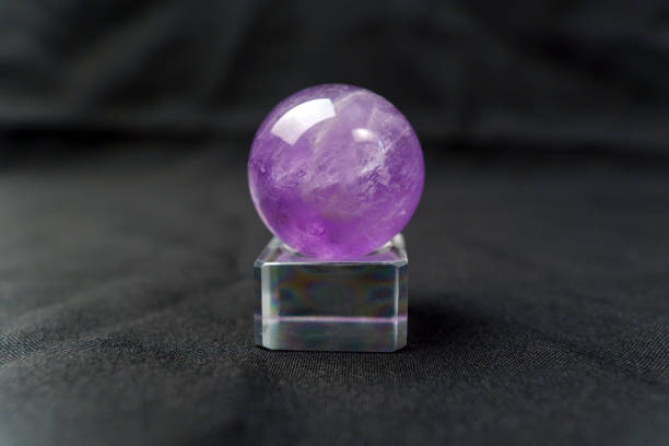 istock Amethyst stone, purple colored crystal stone for jewelry making. Black background. Selective focus 1438981796