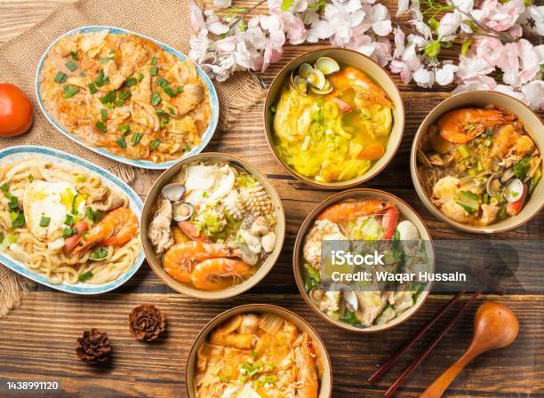 Assorted Hot Pot Curry Pot Roasted Noodles Fried Udon Gout Hot Pot Spicy Kimchi Hot Pot Sacha Pot Pork Risotto With Tomato And Chopsticks Served In Dish On Wooden Table Top View Of Chines Food Stock Photo - Download Image Now