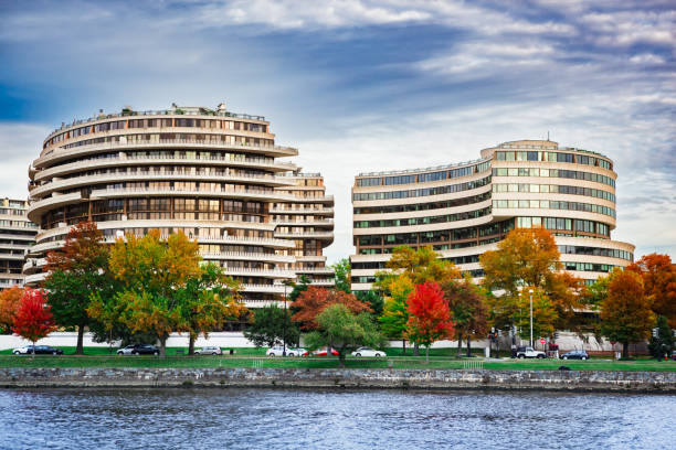 Watergate Hotel from the Potomac River The Watergate Hotel complex from the Potomac River in Washington, DC in autumn hotel watergate stock pictures, royalty-free photos & images