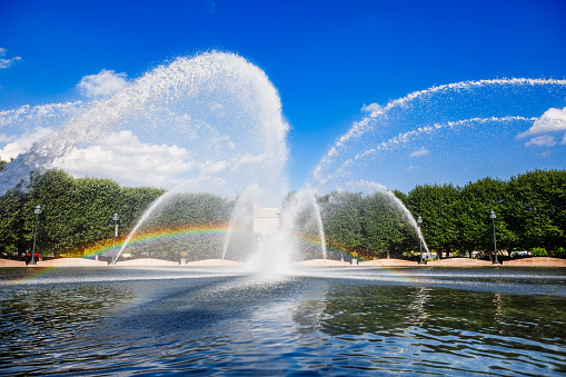 Water fountain spraying arches that form a rainbow at the National Gallery of Art Sculpture Garden in Washington, DC